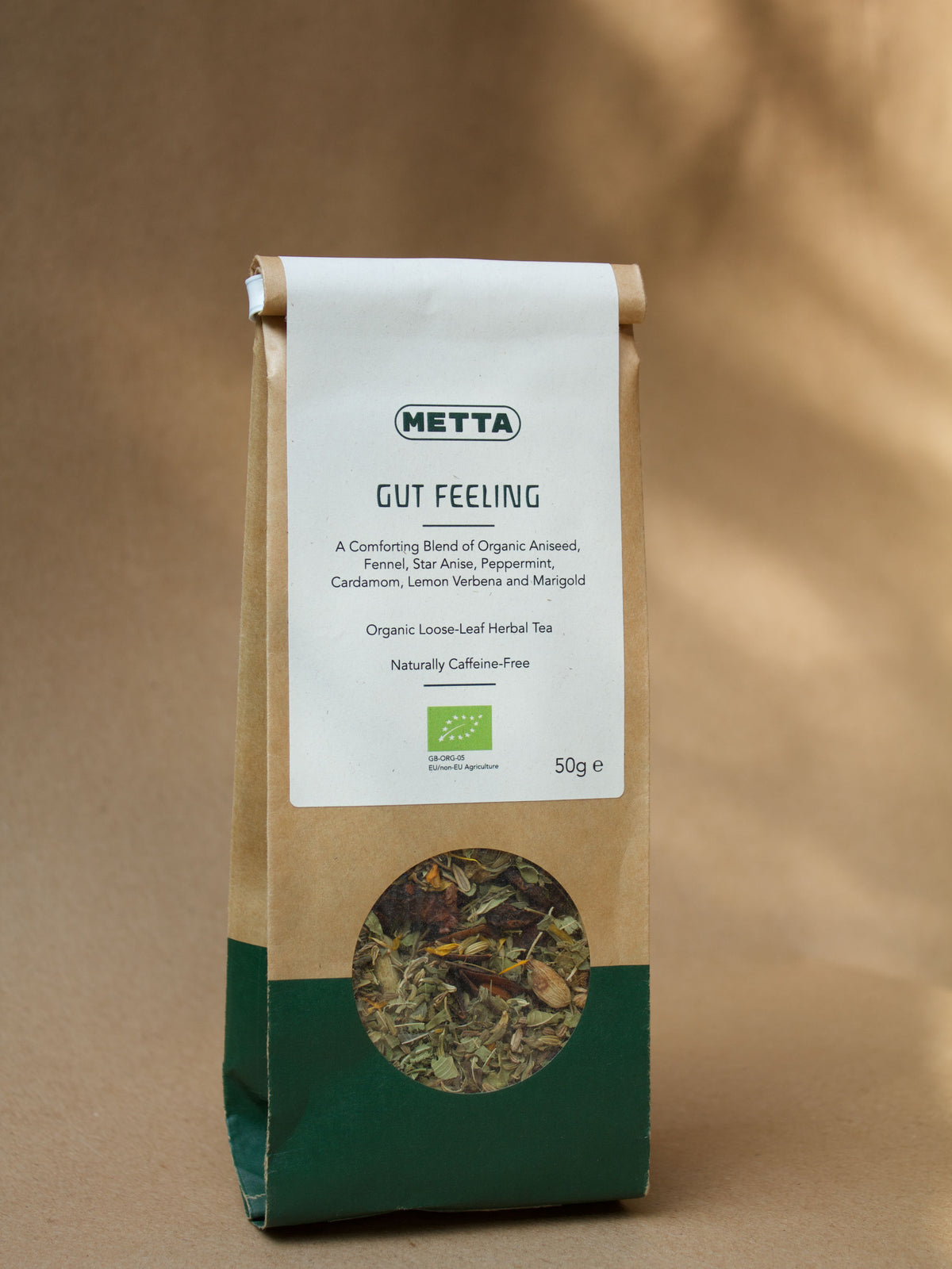 Gut Feeling loose-leaf herbal tea — star anise, cardamom and fennel visible through the kraft pouch window.