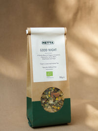 Good Night loose-leaf herbal tea — chamomile flowers, hops and cinnamon bark visible through the kraft pouch window.